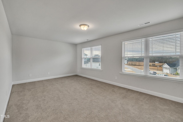 unfurnished room featuring carpet