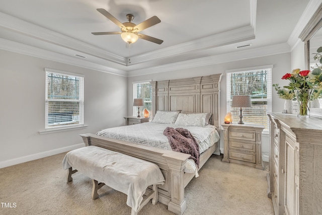 bedroom featuring ceiling fan, a raised ceiling, ornamental molding, and light carpet