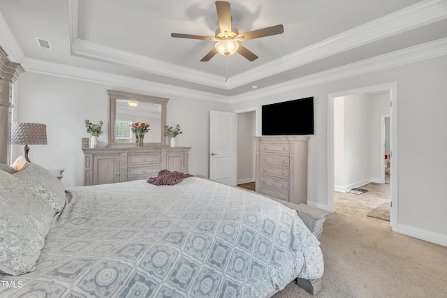 bedroom with light carpet, a tray ceiling, ceiling fan, and ornamental molding