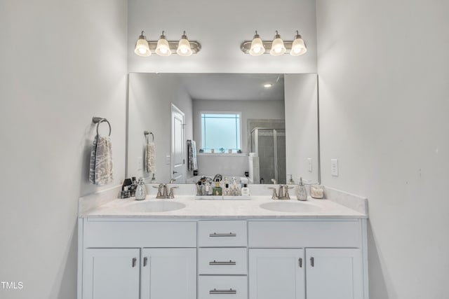 bathroom with vanity and a shower with shower door