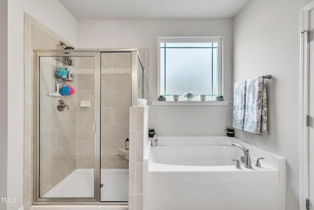 bathroom with shower with separate bathtub