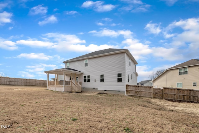 rear view of house with a yard