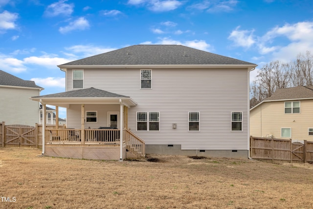 back of house featuring a yard and a wooden deck