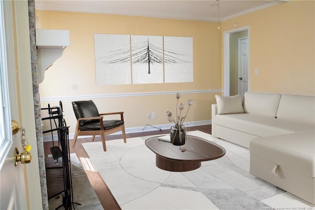 living area featuring crown molding and hardwood / wood-style floors