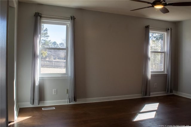 unfurnished room featuring dark hardwood / wood-style floors and ceiling fan