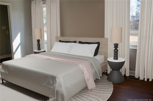 bedroom featuring multiple windows and hardwood / wood-style flooring