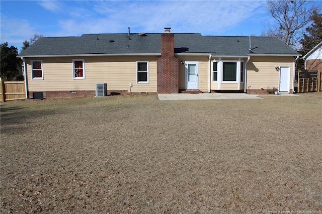 back of property with a yard, central air condition unit, and a patio area