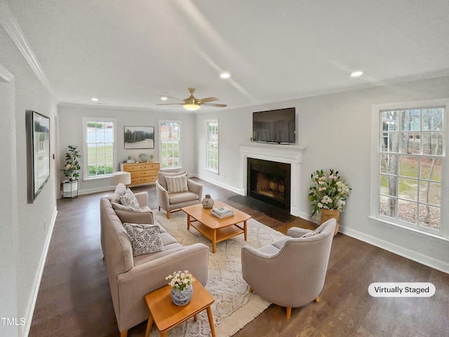 living room with ceiling fan, crown molding, and a wealth of natural light