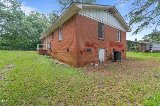 view of property exterior with a lawn and central AC