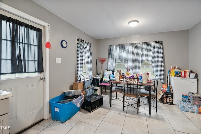 dining room featuring light tile patterned flooring and a wealth of natural light