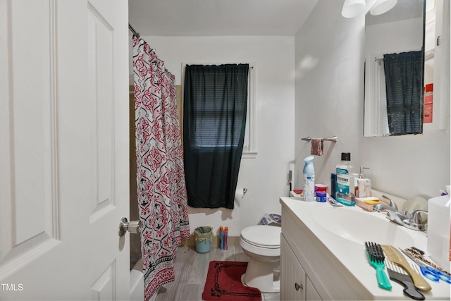 bathroom with vanity, curtained shower, toilet, and wood-type flooring