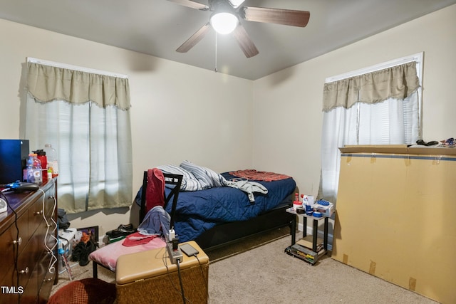 bedroom featuring ceiling fan and carpet