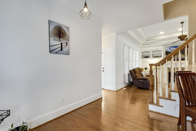 foyer with hardwood / wood-style flooring, ceiling fan, and ornamental molding