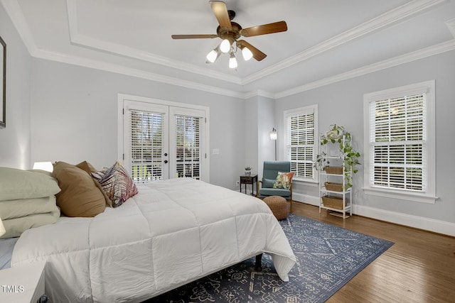 bedroom featuring french doors, access to outside, a raised ceiling, ceiling fan, and dark hardwood / wood-style floors