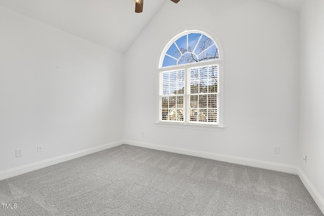 carpeted empty room with ceiling fan and vaulted ceiling