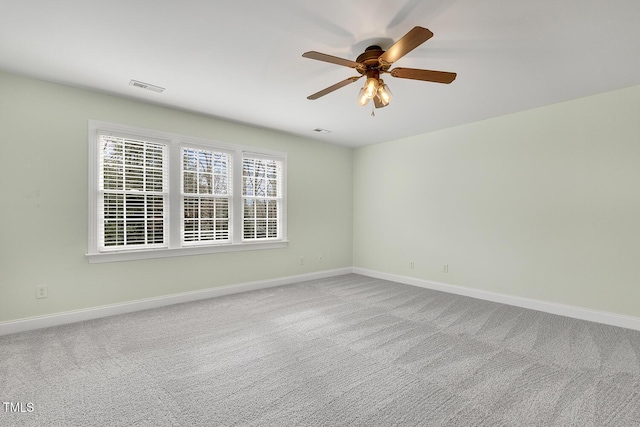 unfurnished room featuring ceiling fan and carpet