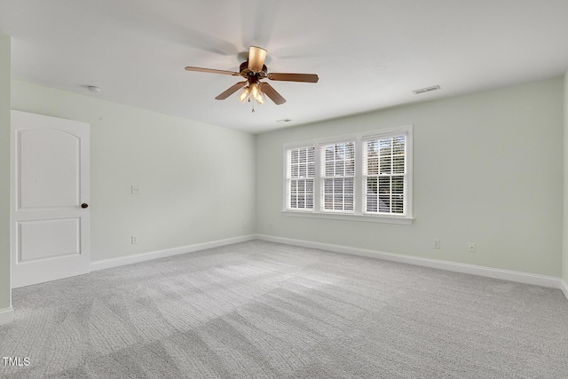 empty room with light colored carpet and ceiling fan