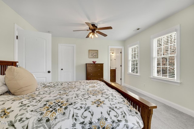 bedroom with carpet flooring, connected bathroom, and ceiling fan