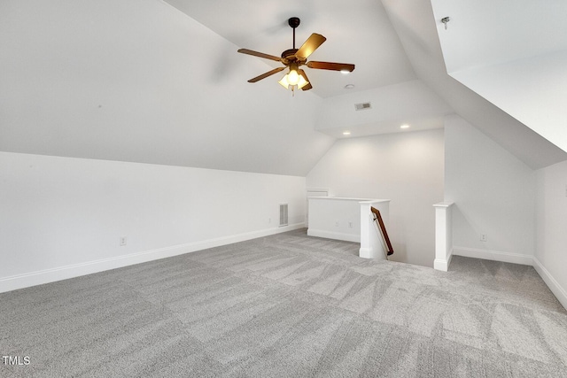 additional living space featuring light carpet, vaulted ceiling, and ceiling fan