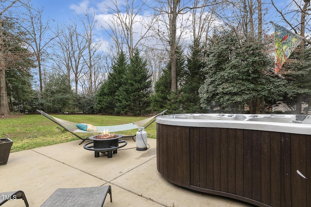 view of patio / terrace featuring a hot tub and a fire pit