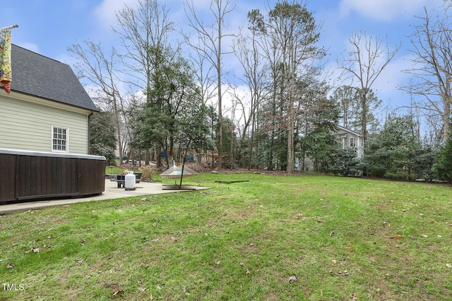 view of yard featuring a jacuzzi and a patio