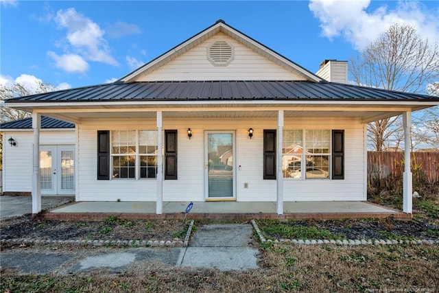 view of front facade with a porch and french doors