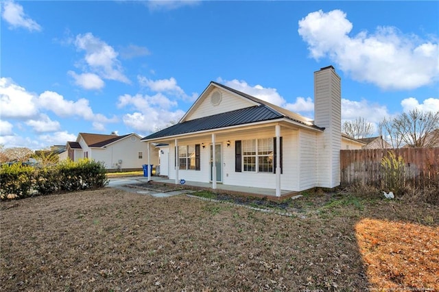 view of front of home featuring a front yard and a porch