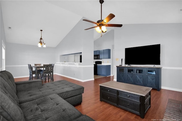 living room featuring ceiling fan with notable chandelier, dark hardwood / wood-style flooring, and high vaulted ceiling