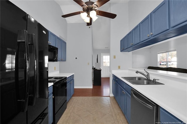 kitchen with sink, black appliances, vaulted ceiling, and blue cabinets