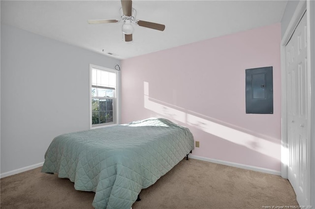 carpeted bedroom featuring ceiling fan, electric panel, and a closet