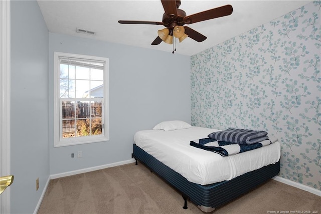 bedroom featuring ceiling fan and light carpet