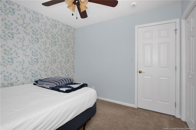 bedroom with ceiling fan, a closet, and light carpet