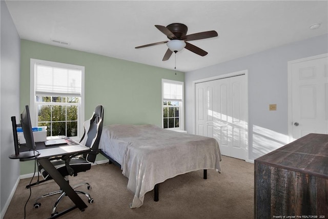 bedroom featuring multiple windows, ceiling fan, and light carpet