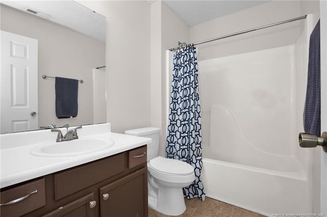 full bathroom with vanity, toilet, wood-type flooring, and shower / tub combo