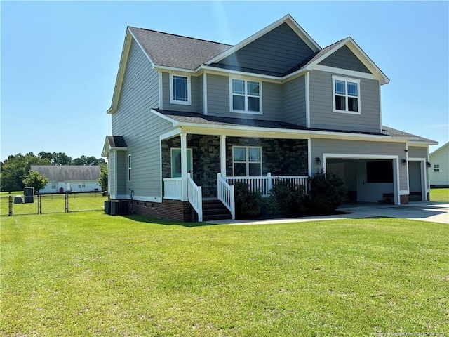 view of front of home featuring central AC, a front lawn, a porch, and a garage