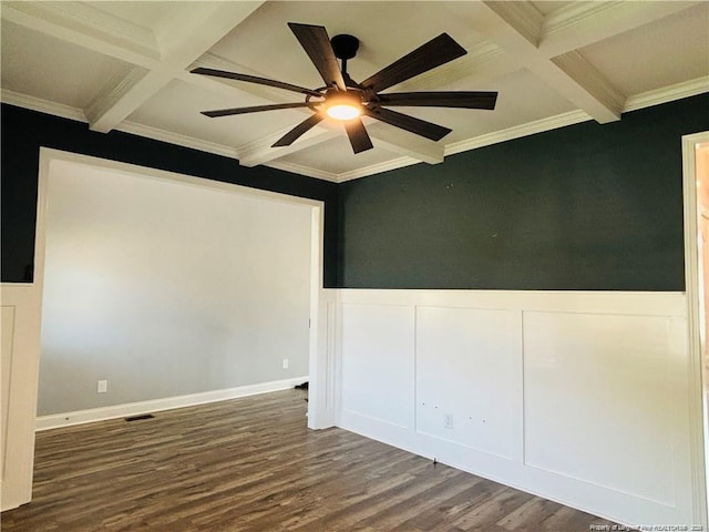 empty room featuring beam ceiling, dark hardwood / wood-style flooring, ornamental molding, and coffered ceiling