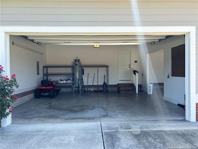 garage featuring electric water heater and electric panel