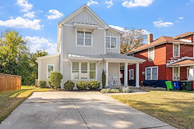 view of front of house featuring covered porch and a front lawn