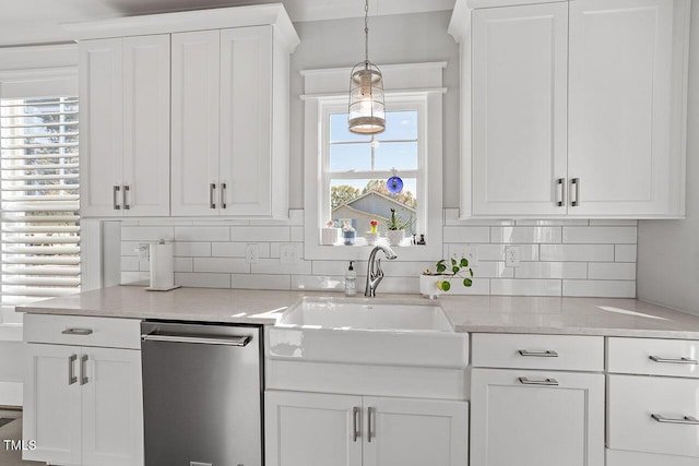 kitchen featuring stainless steel dishwasher, decorative light fixtures, decorative backsplash, and white cabinetry