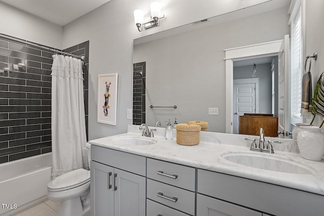 full bathroom featuring shower / bathtub combination with curtain, tile patterned floors, vanity, and toilet