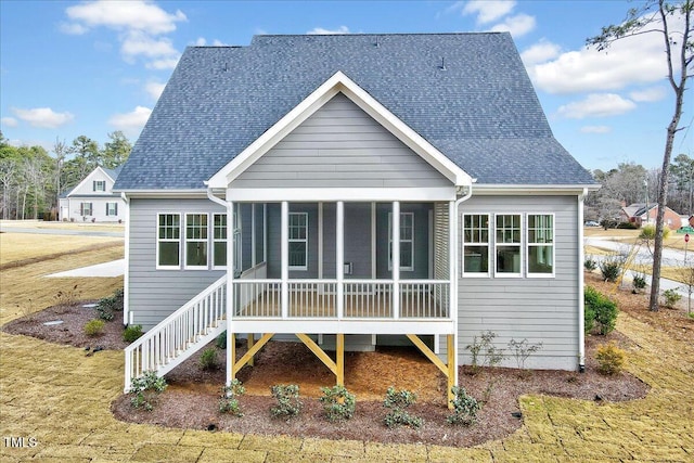 back of property with a sunroom