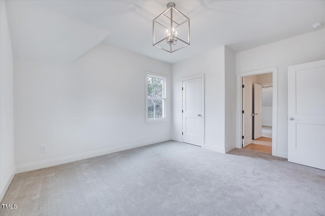 interior space with light carpet and a notable chandelier