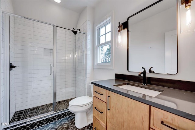 bathroom featuring walk in shower, vanity, and toilet