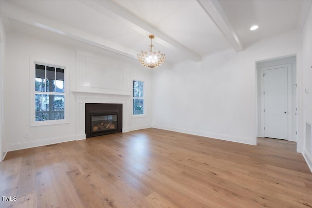 unfurnished living room with beam ceiling, light wood-type flooring, and an inviting chandelier