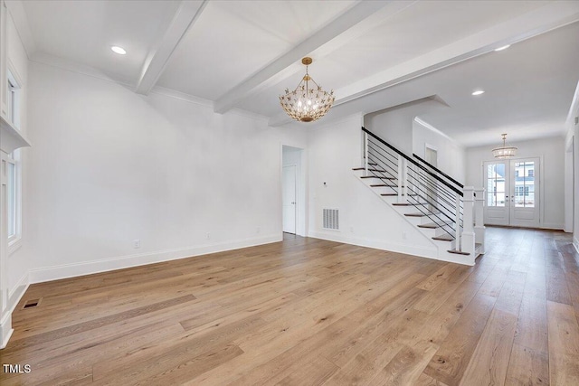 interior space with a notable chandelier, beam ceiling, light wood-type flooring, and french doors