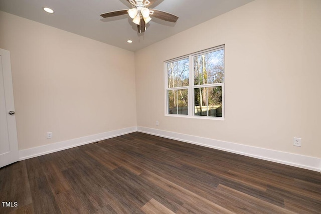 unfurnished room with ceiling fan and dark hardwood / wood-style flooring