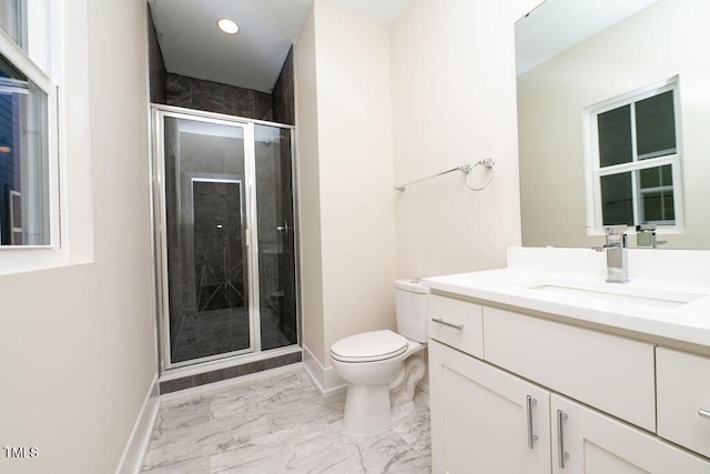 bathroom with vanity, toilet, and a shower with shower door