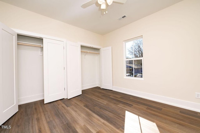 unfurnished bedroom featuring ceiling fan and dark wood-type flooring