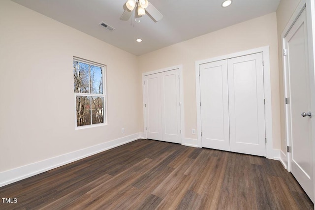 unfurnished bedroom featuring dark hardwood / wood-style floors and ceiling fan