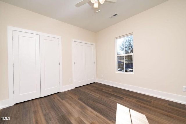 unfurnished bedroom with ceiling fan and dark hardwood / wood-style floors